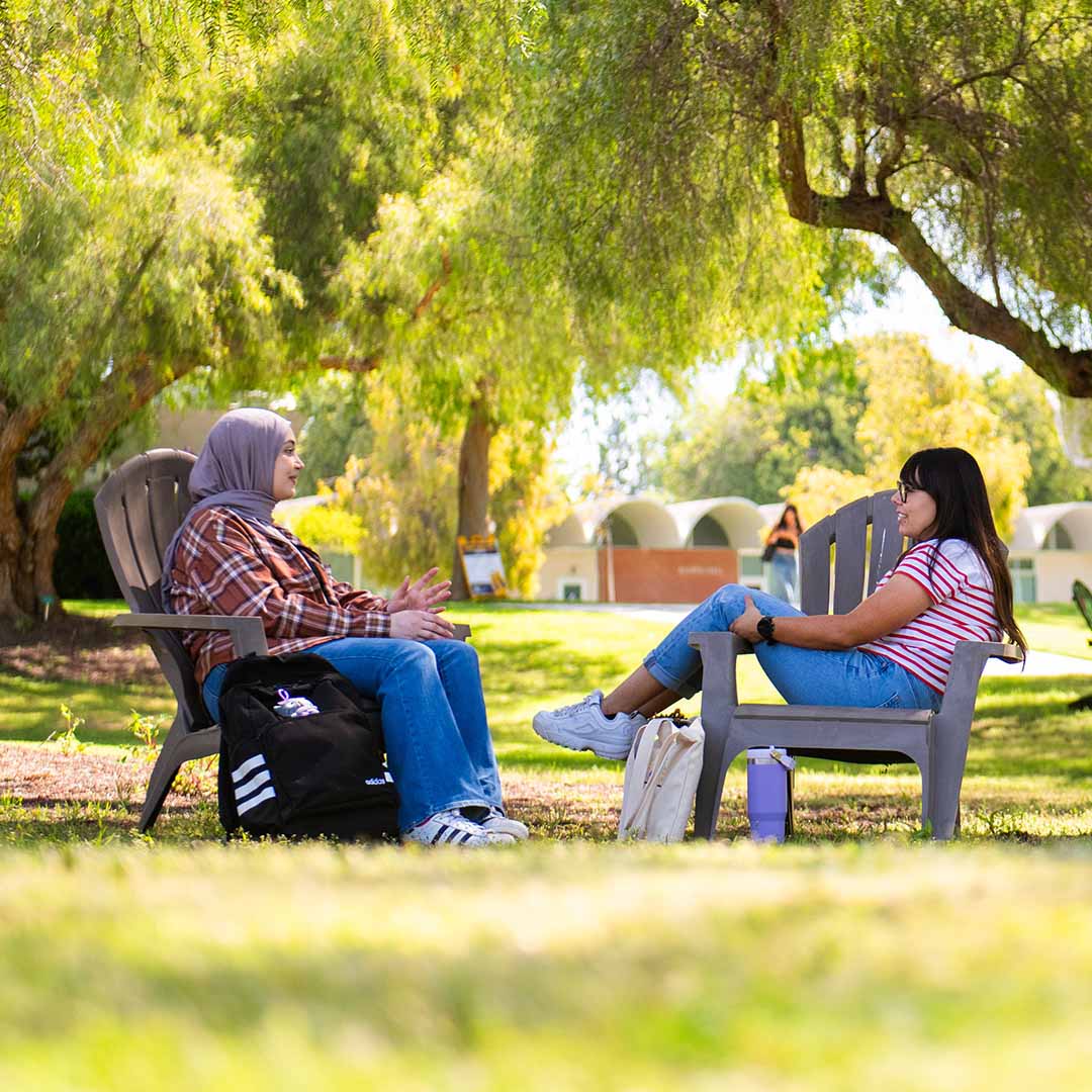 Two students talking on campus